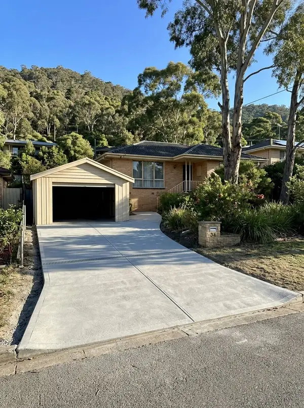 New broom-finished sloping driveway with a strip drain at the garage, Beaumont