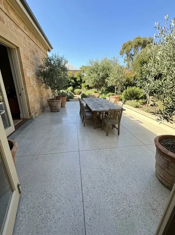 Honed concrete courtyard behind a sandstone home, Tusmore