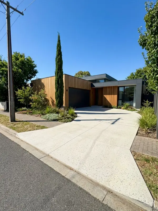 Pale honed concrete driveway at a contemporary home, Norwood