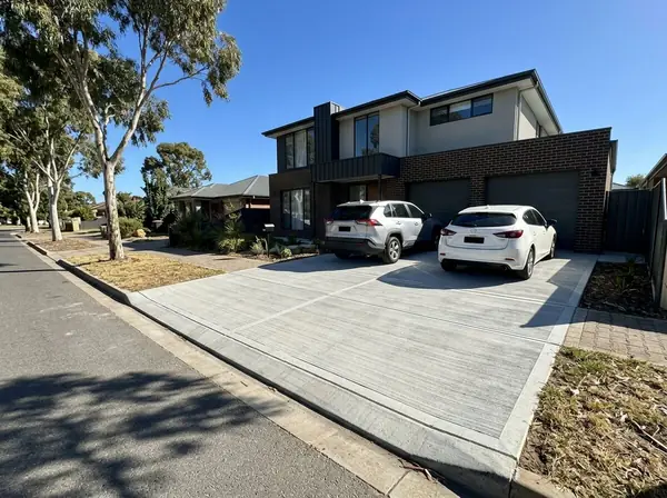 Wide double concrete driveway in front of a two-storey home, Adelaide