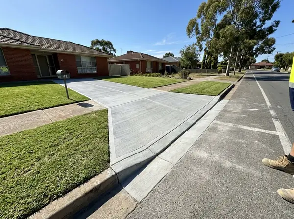 New concrete crossover and driveway entry meeting the road kerb