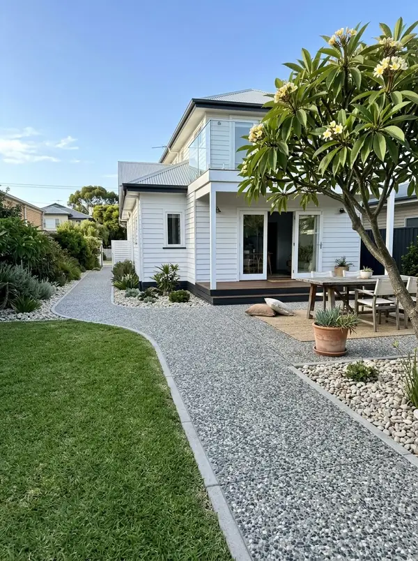 Coastal white exposed aggregate alfresco at a weatherboard beach house, Henley Beach