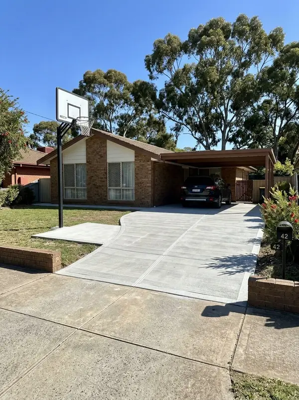 New broom-finished driveway and carport apron at a 1980s brick home, Surrey Downs