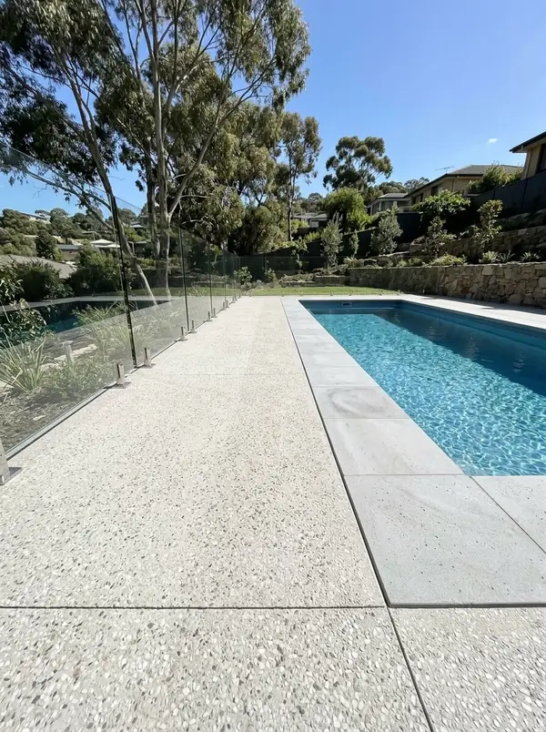 Pale exposed aggregate pool surround on a terraced block, Golden Grove