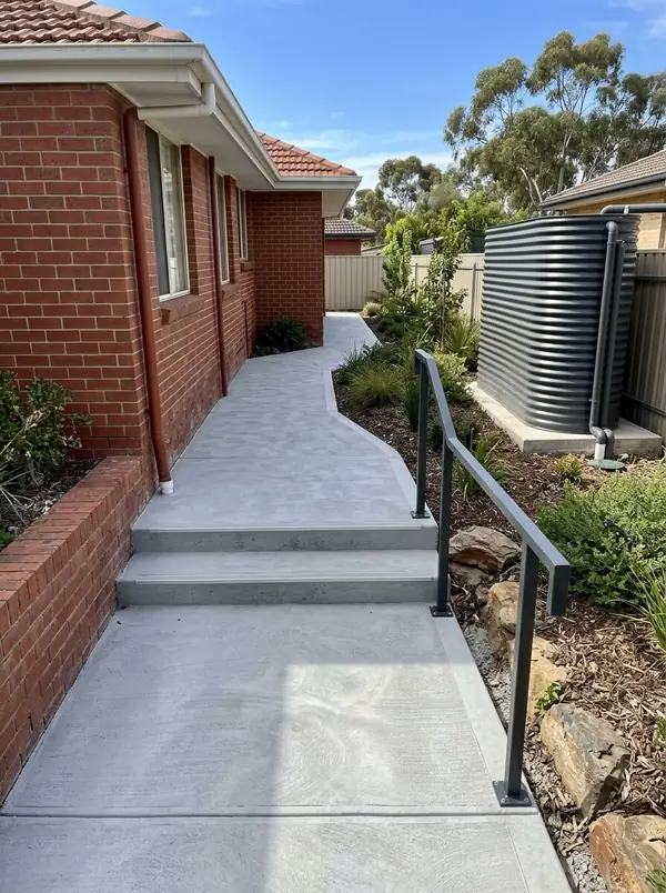 New concrete side path with steps down a sloping block, Fairview Park