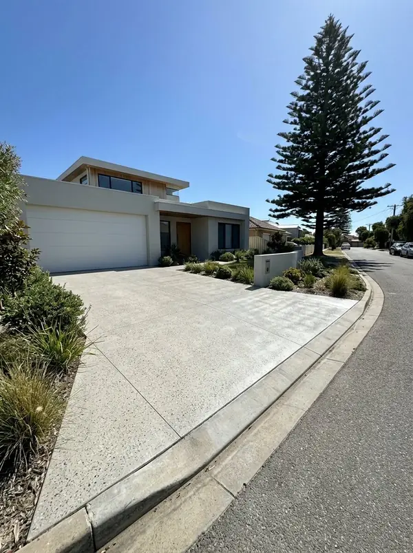 Pale honed concrete driveway at a flat-roofed coastal home, Henley Beach