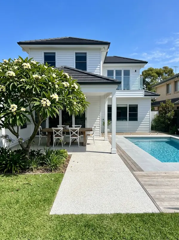 Coastal white exposed aggregate alfresco with a frangipani, Henley Beach