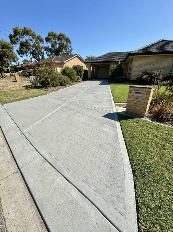 New broom-finished driveway at a 1960s cream brick home, Fulham