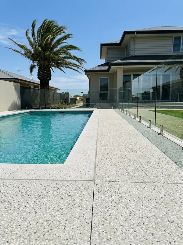 Pale exposed aggregate pool surround at a two-storey home, Henley Beach South