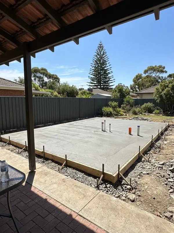 Granny flat slab in a backyard with a Norfolk pine beyond, West Beach