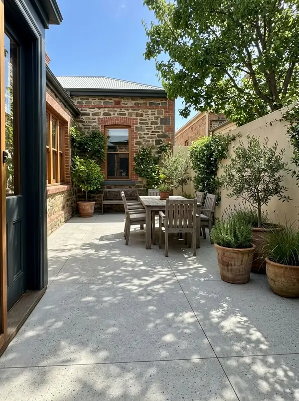 Honed concrete courtyard behind a bluestone villa, Unley