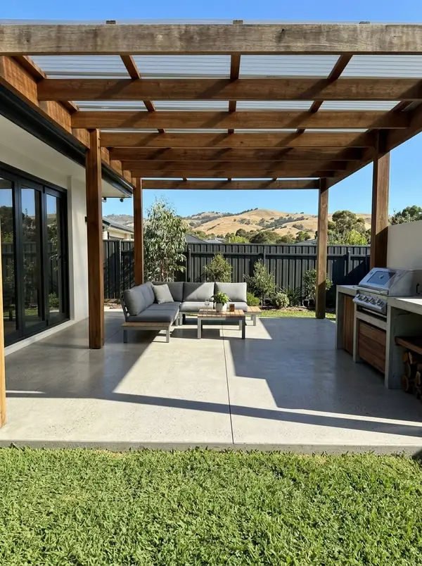 Honed concrete alfresco floor under a timber pergola, Burnside
