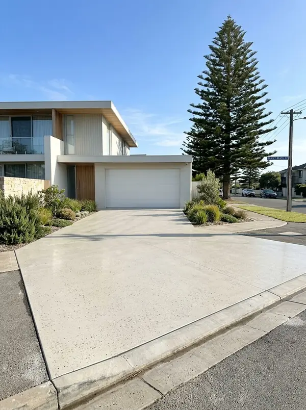 Pale honed concrete driveway at a flat-roofed coastal home, Henley Beach