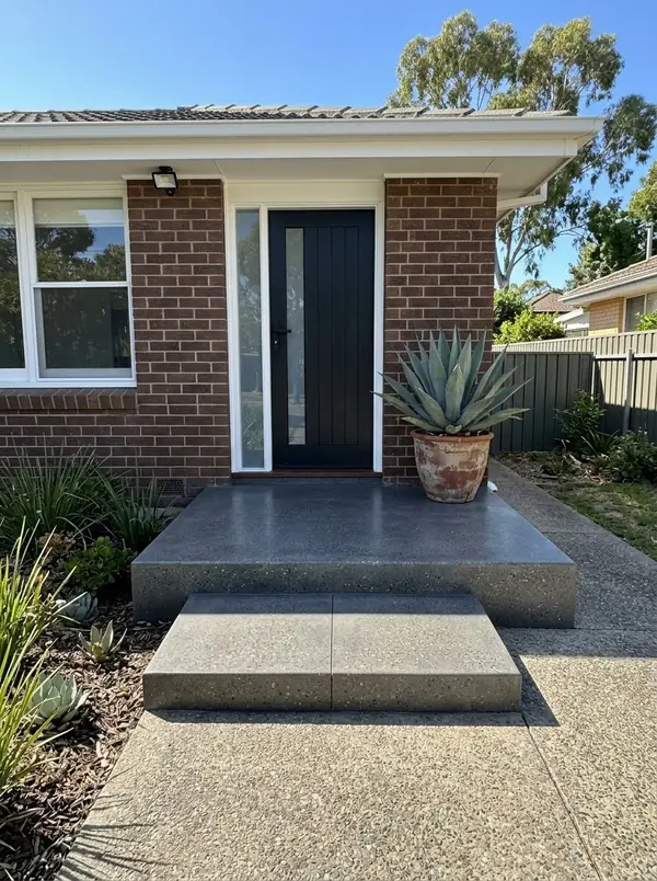 Charcoal honed concrete porch at a renovated 1970s home, Prospect