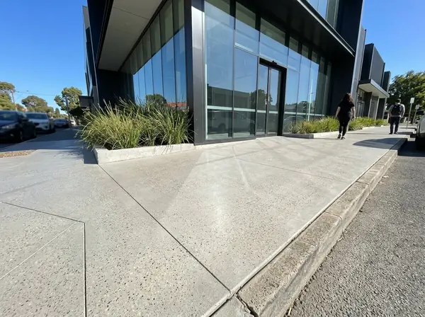 Honed concrete showroom forecourt with a glass shopfront