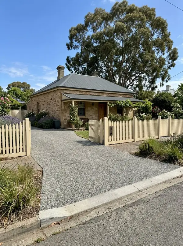 Natural grey exposed aggregate driveway at an 1850s stone cottage in the old village, Mitcham