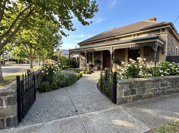 A new exposed aggregate driveway and entry path at a bluestone villa on a street of plane trees in Norwood