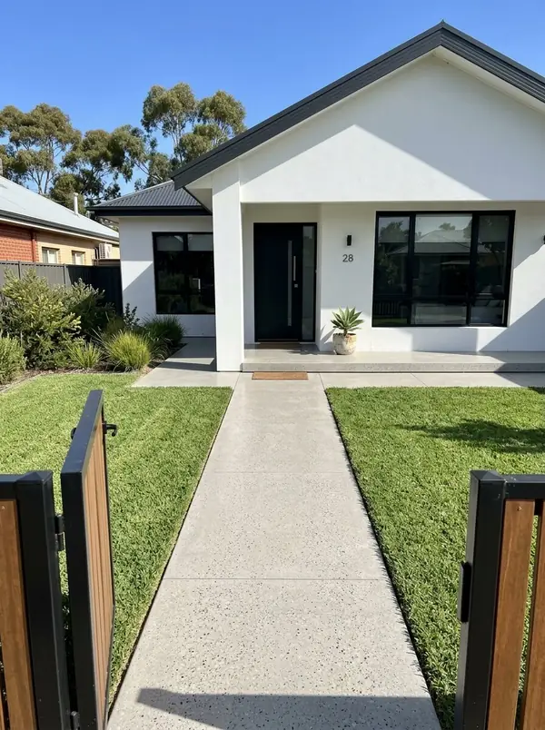 Honed concrete front path and porch at a white rendered home, Norwood