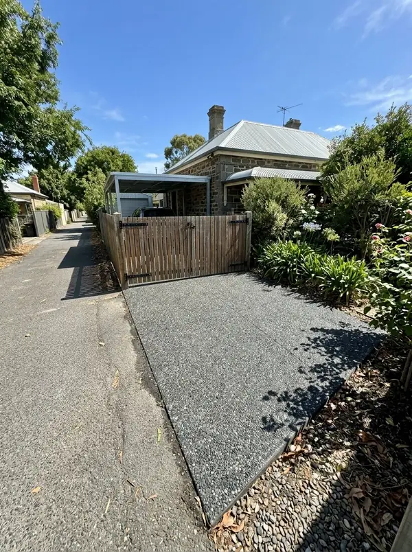 Charcoal exposed aggregate driveway to a carport off a rear lane, Norwood