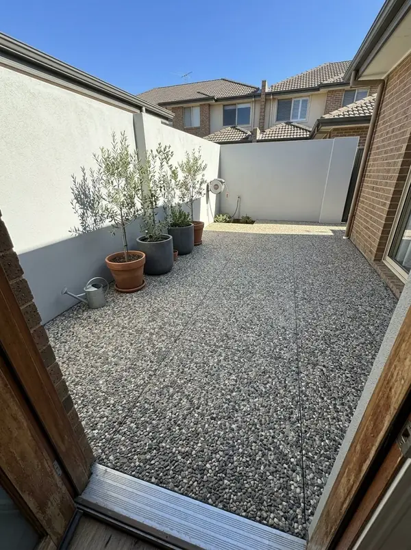 Oatmeal exposed aggregate courtyard behind a townhouse, Kent Town