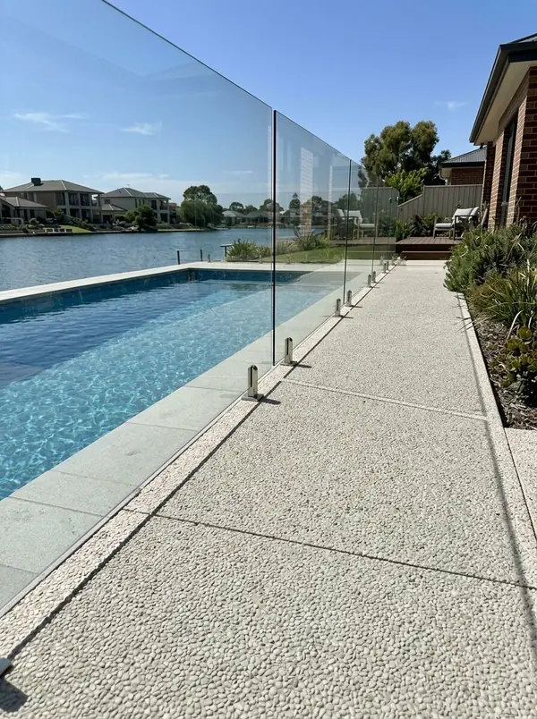 Pale exposed aggregate pool surround with a lake view, West Lakes