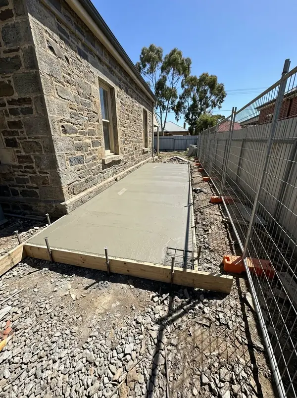 Rear extension slab poured against the back of a bluestone villa, Prospect
