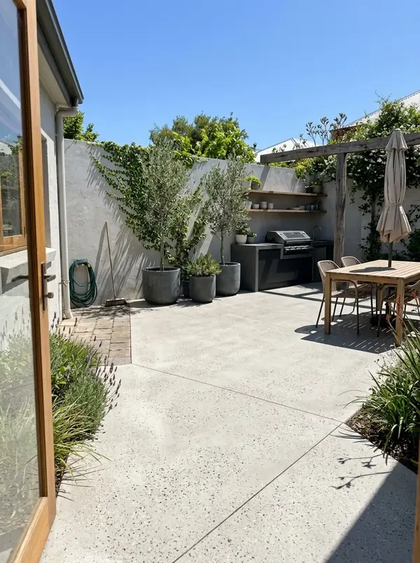 Honed concrete courtyard and alfresco behind a villa, Fitzroy