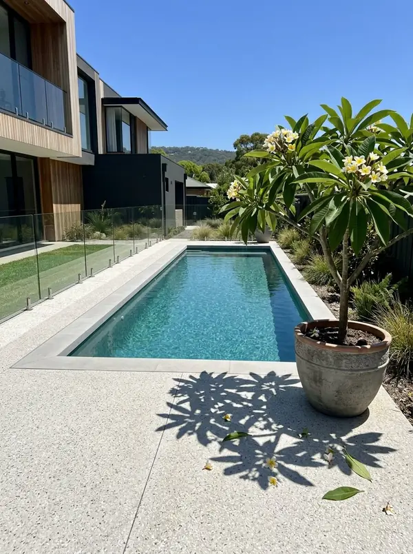 Pale exposed aggregate surround around a rectangular pool, Burnside