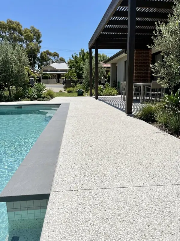 Pale exposed aggregate pool surround flowing into an alfresco floor, Mitcham
