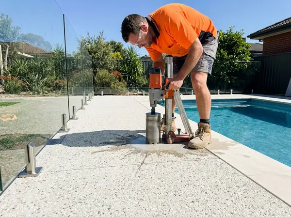 Core-drilling a hole for a glass pool fence spigot into a new surround