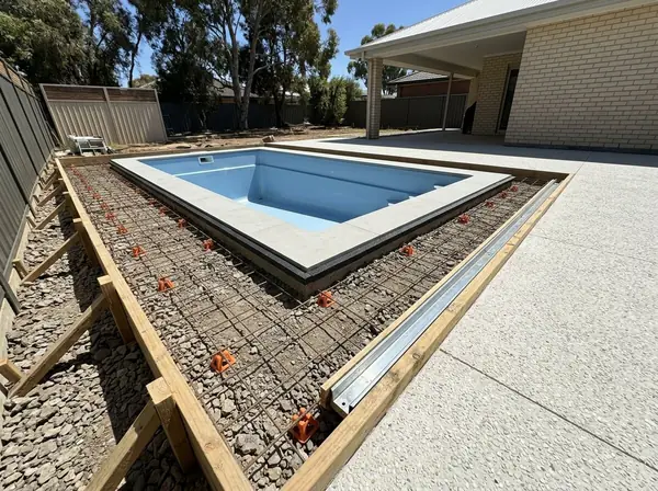A pool surround formed up with mesh, a strip drain and an expansion joint at the coping
