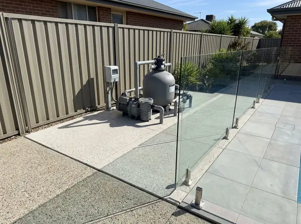 A neat concrete pad with a pool pump and filter on it