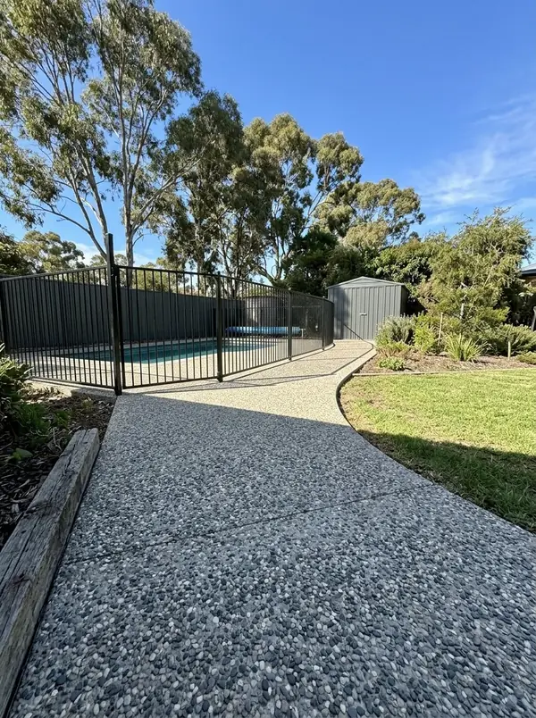 Oatmeal exposed aggregate path around a pool fence to a shed, Happy Valley