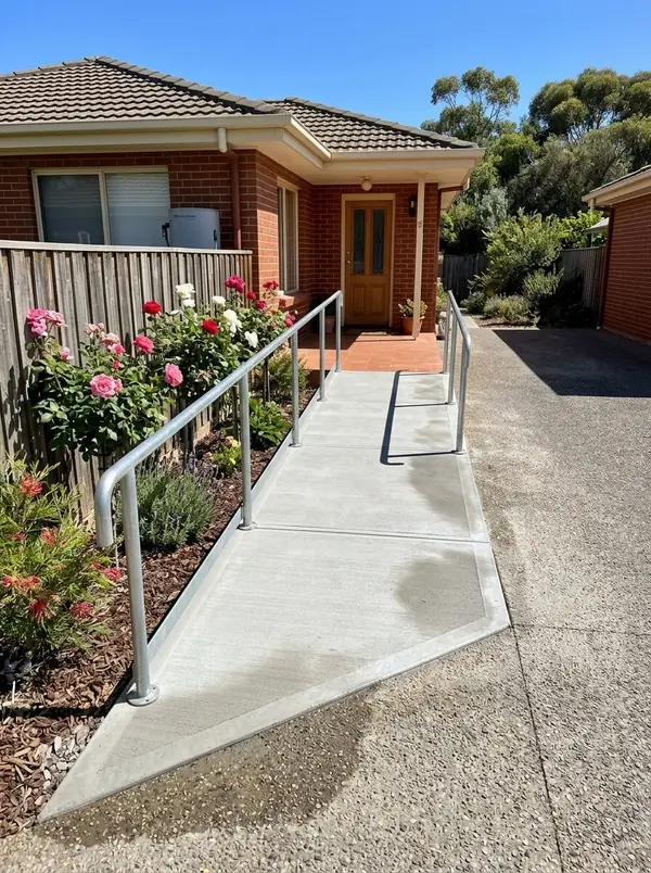 Concrete path with a gentle ramp and handrail to a unit's front door, Mitcham