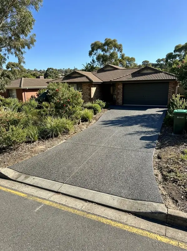 Charcoal exposed aggregate double driveway at a 1980s brick veneer home, Salisbury Heights