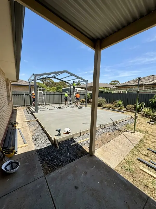 Shed slab with the Colorbond frame going up in a big backyard, Paralowie