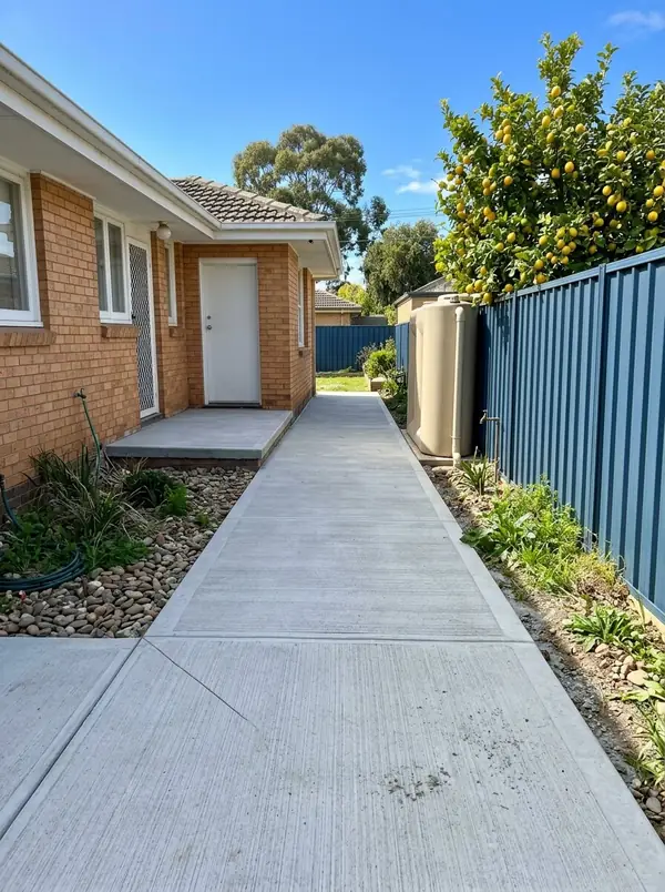 New concrete side path and landing at the back door of a 1970s brick home, Brahma Lodge