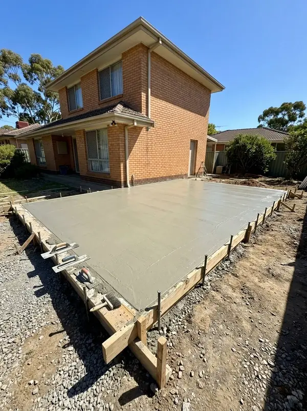Freshly poured double garage slab beside a brick veneer home, Modbury