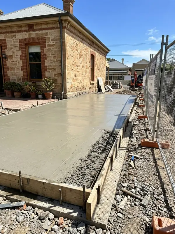 Rear extension slab poured against a sandstone villa, Unley