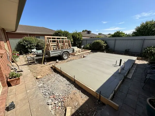 Granny flat slab with plumbing stubs in a back garden