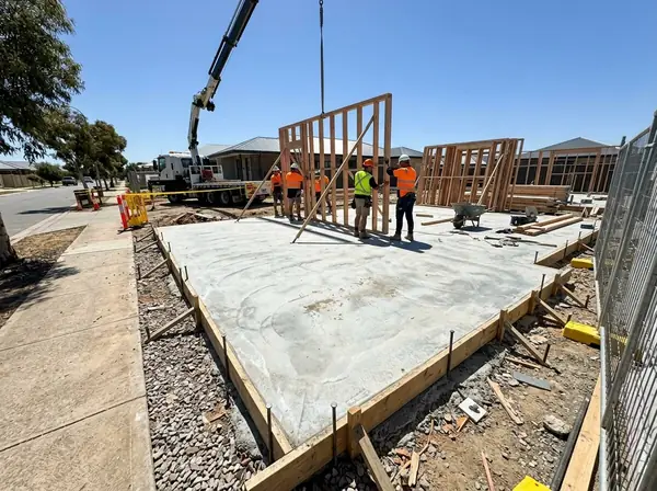 Waffle pod house slab with timber frames being stood up on it