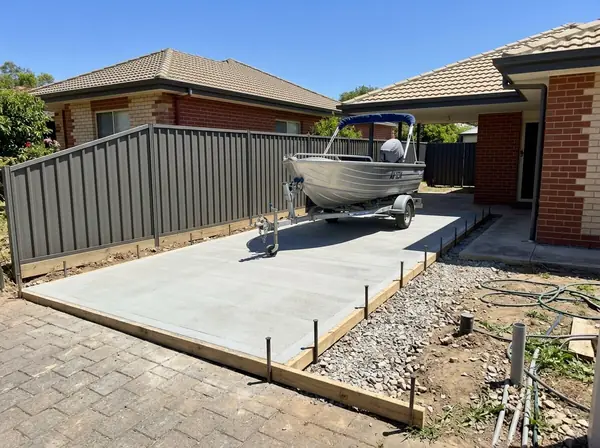 Concrete hardstand with a boat on a trailer parked on it